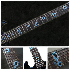 Close-up of a guitar neck with bullet  inlays