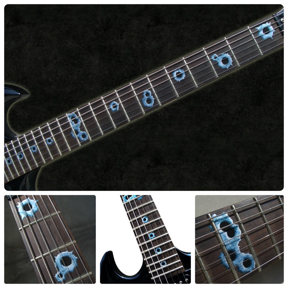 Close-up of a guitar neck with bullet  inlays