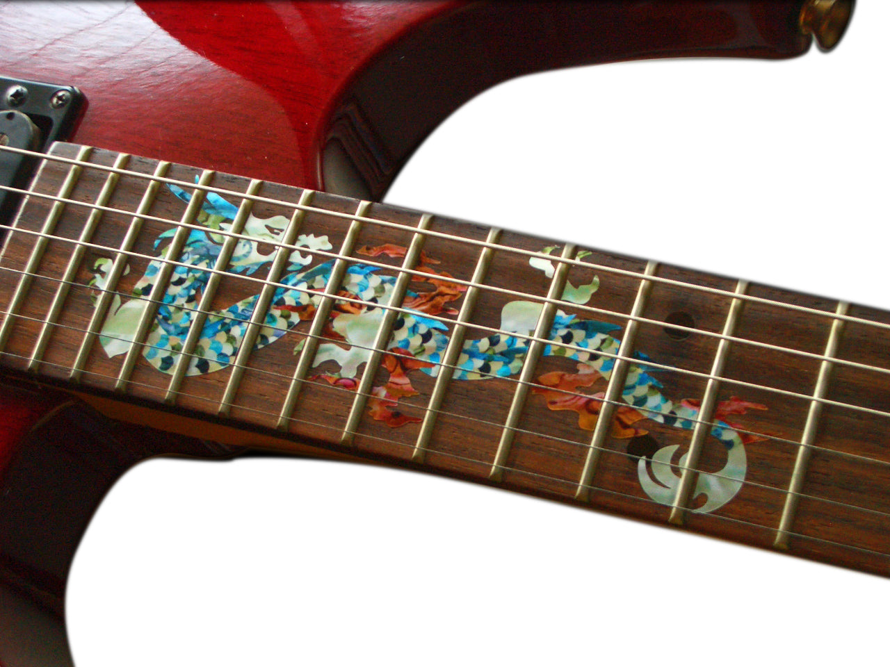 Close-up of a guitar neck with decorative inlay on a white background