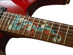 Close-up of a guitar neck with decorative inlay on a white background