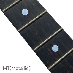 Close-up of a guitar fretboard with metallic dot inlay stickers
