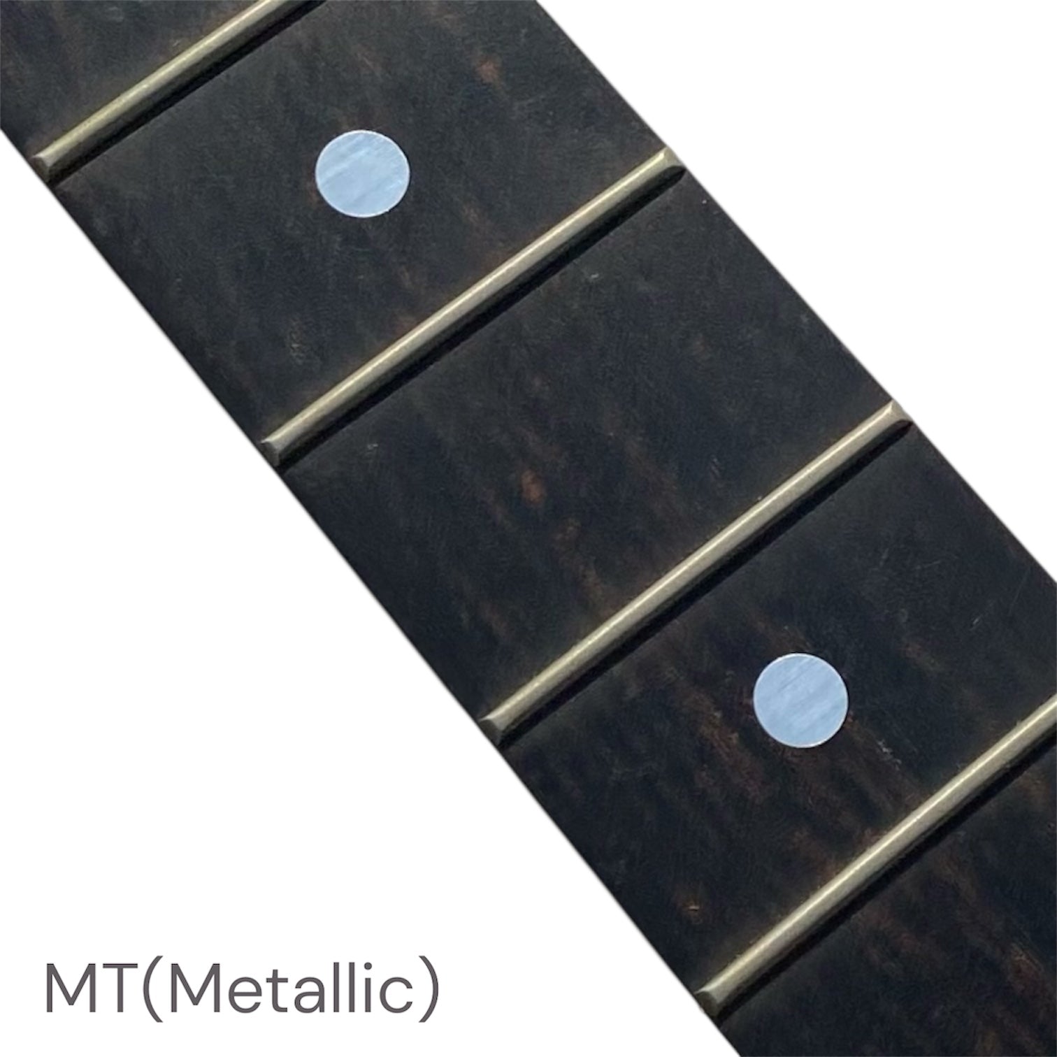 Close-up of a guitar fretboard with metallic dot inlay stickers