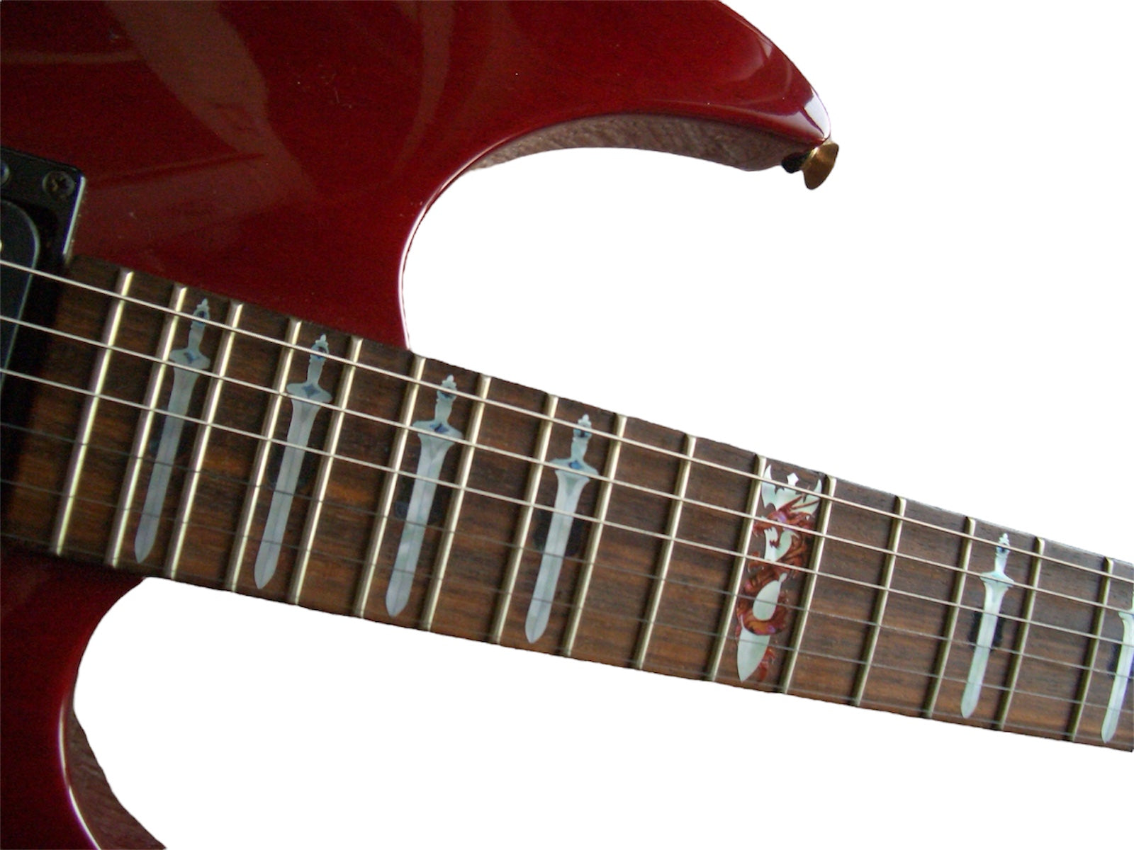 Close-up of a red electric guitar's neck with dragon inlay