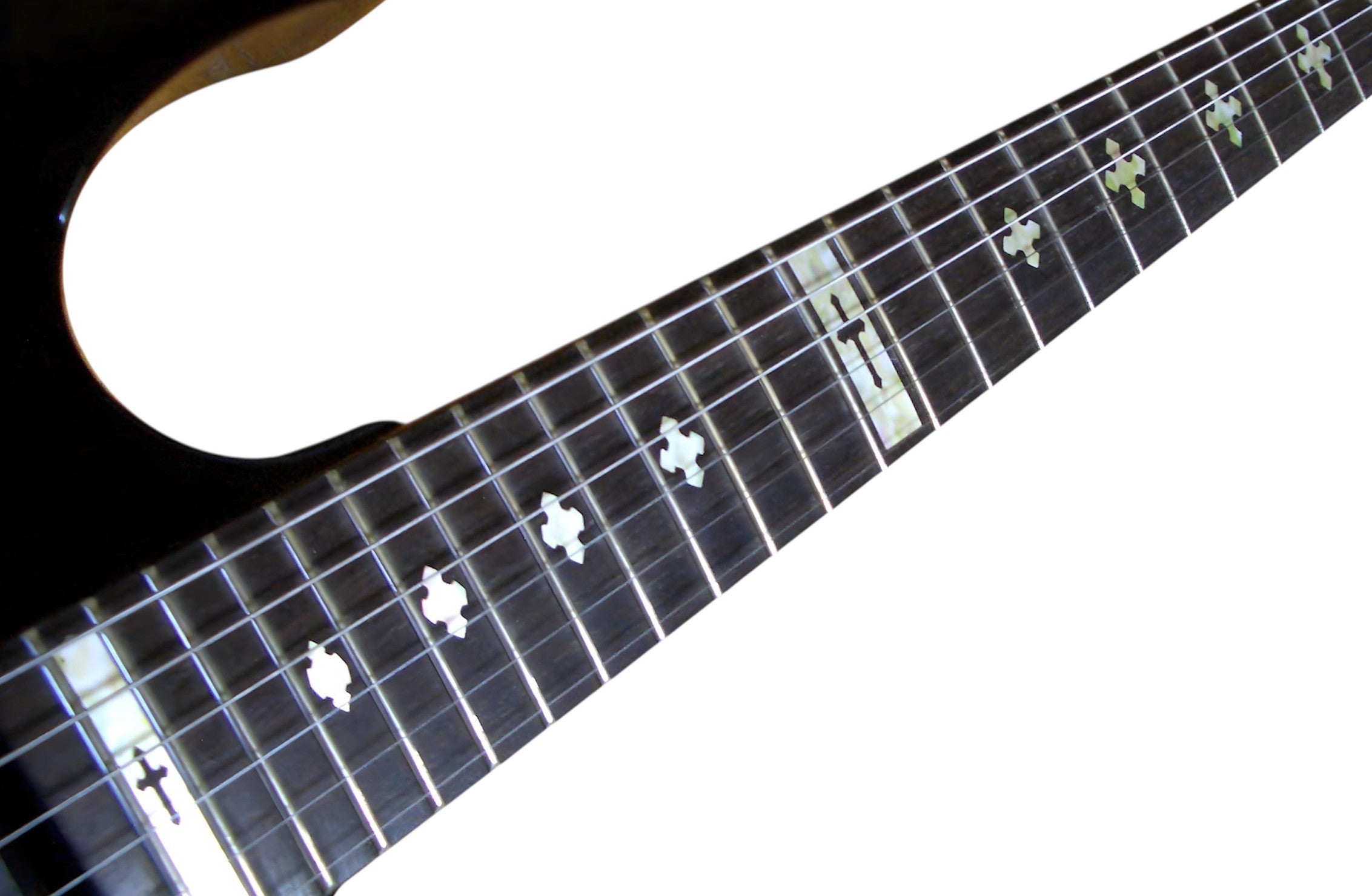 Close-up of a guitar neck with Cross fret markers